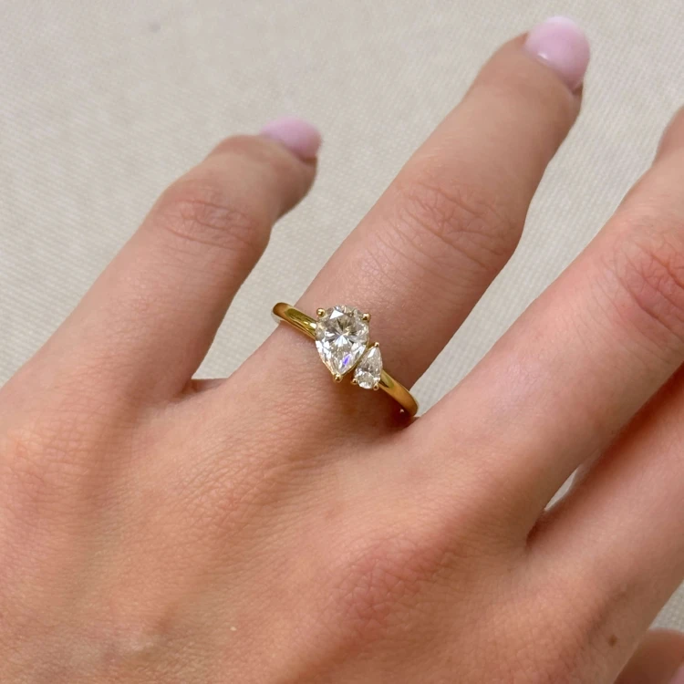 Verlobungsring-Toi-et-Moi-Moissanit-1-6ct-Birnschliff-am-Finger-Gelbgold-Twin-Pears-Hariets.jpg