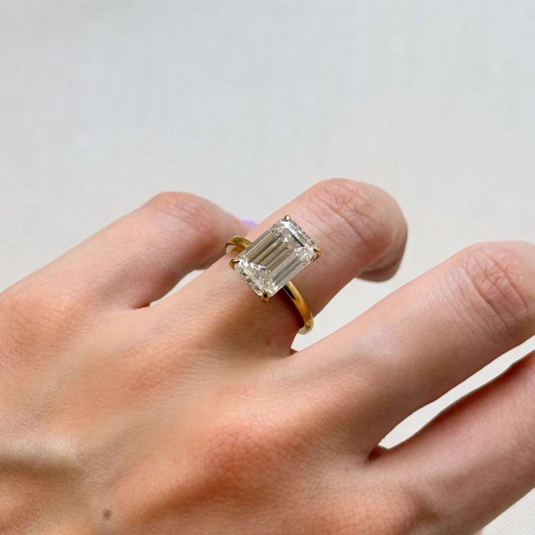 verlobungsring-royal-stones-moissanit-5ct-smaragdschliff-am-finger-seite-gelbgold-nobilis-hariets.JPG