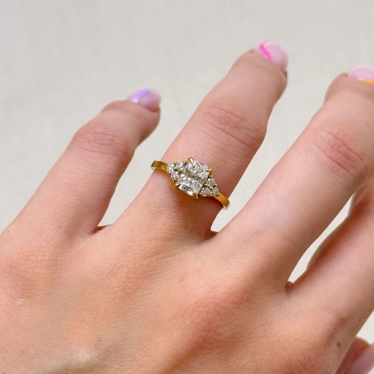 verlobungsring-trinity-moissanit-1ct-radiantschliff-am-finger-gelbgold-legacy-hariets.jpg