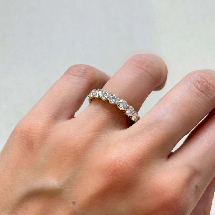 eternity-ring-moissanit-4mm-brillantschliff-am-finger-nahaufnahme-gelbgold-hariets.JPG